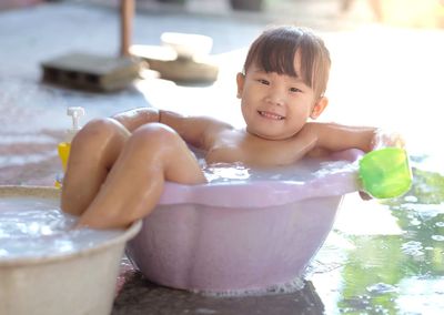 Portrait of smiling boy with water