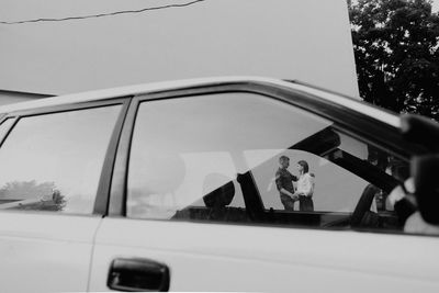 People seen through car window