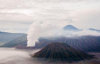 View of volcanic landscape against cloudy sky