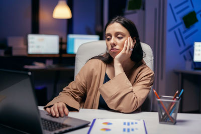 Tired businesswoman working in office