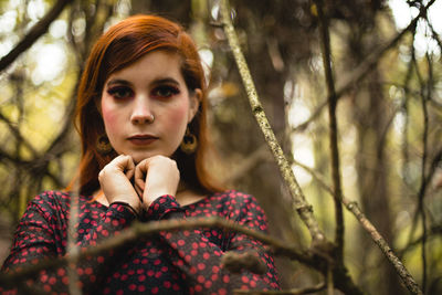 Portrait of young woman standing in forest