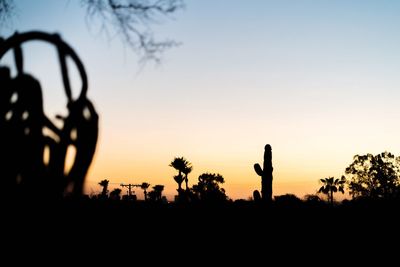 Silhouette trees against sky during sunset