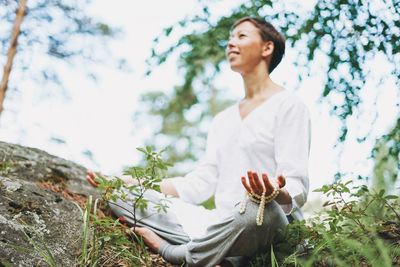 Young smiling woman practice yoga outdoors. new normal social distance. physical and mental health