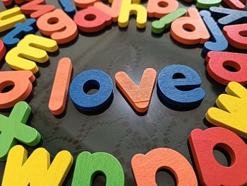 Directly above shot of multi colored toys on table, love letter