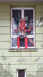 Low angle view of red house window on building