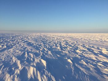 Scenic view of snow covered landscape against clear sky