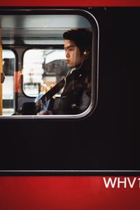 Full length of man traveling in train