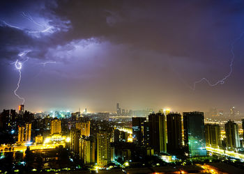 Panoramic view of illuminated city against sky at night