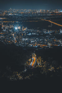 High angle view of illuminated buildings in city at night