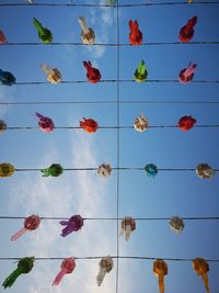 Full frame shot of multi colored umbrellas against blue sky
