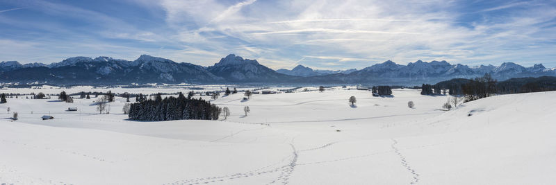 Scenic and panoramic view of snow covered mountains against sky at cold winter day