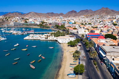 High angle view of townscape and sea against sky