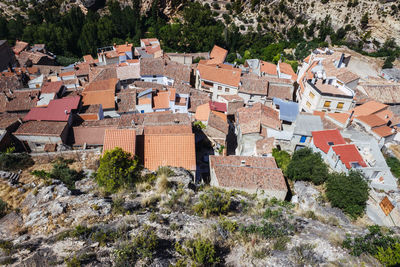 High angle view of houses and trees in city