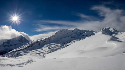 Scenic view of snowcapped mountains against sky