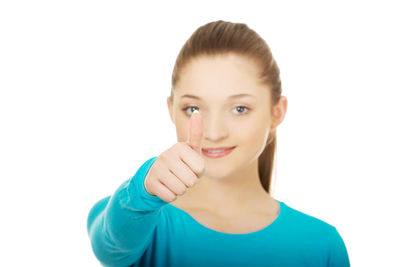 Portrait of smiling young woman against white background