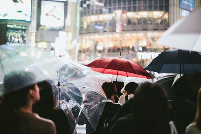 People with umbrella in city