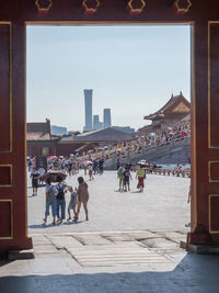 Group of people walking in front of buildings