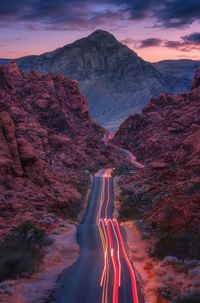 Panoramic view of road through rock formation amidst mountains against sky