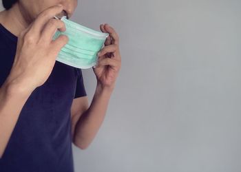 Midsection of woman drinking water from glass