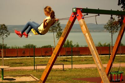 Girl swinging in park