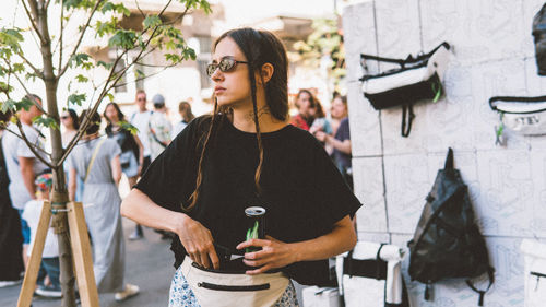 Full length of senior woman standing against plants