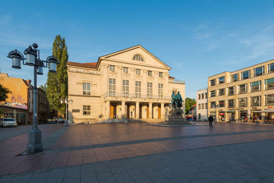 Street amidst buildings in town against sky