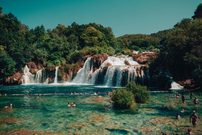 Scenic view of waterfall against sky