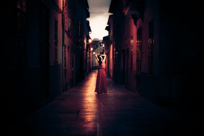 Rear view of woman walking in corridor of building