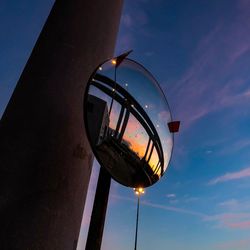 Low angle view of illuminated street light against sky