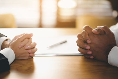 Close-up of woman hand on table