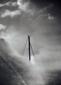 Low angle view of cranes against sky