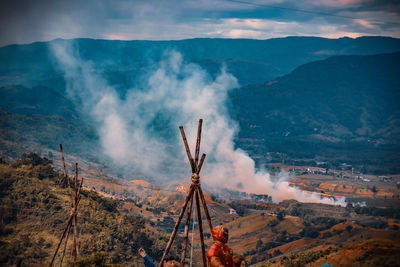 Panoramic view of smoke emitting from volcanic mountain