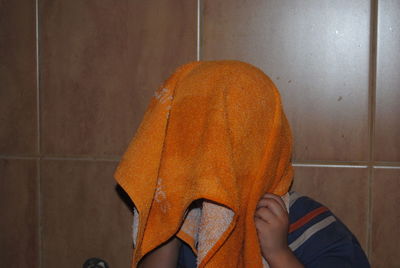 Portrait of child standing on wall at home