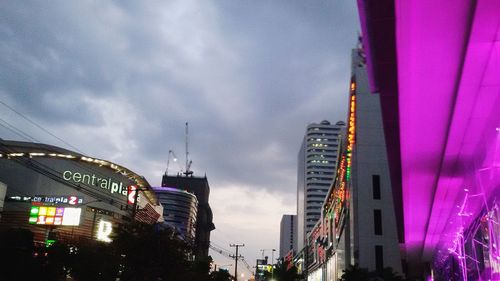 Low angle view of buildings against cloudy sky