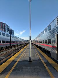 Train at railroad station against sky