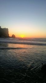 Scenic view of sea against clear sky during sunset