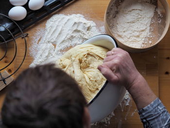 Midsection of person preparing food in kitchen