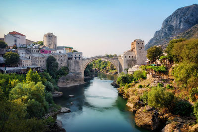 Bridge over river with buildings in background