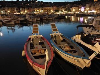 Panoramic view of boats moored at night