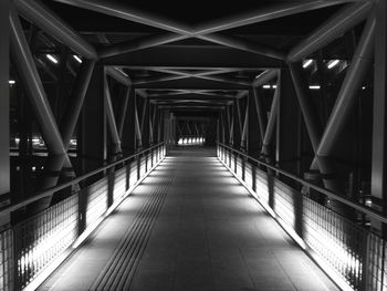 Empty illuminated bridge at night