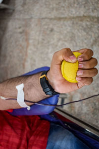 Blood donor at blood donation camp held with a bouncy ball holding in hand at balaji temple