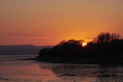 Scenic view of sea against romantic sky at sunset