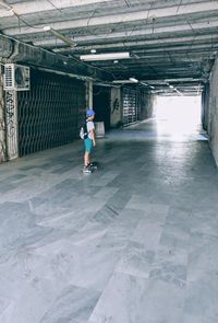 Full length of man skateboarding on floor