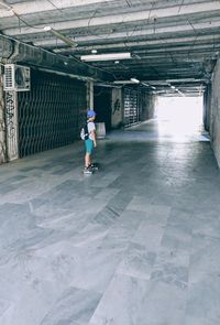Full length of man skateboarding on floor