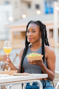 Portrait of woman holding drink