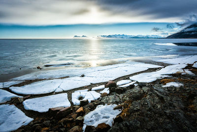 Scenic view of sea against cloudy sky