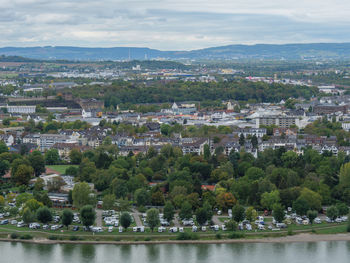 High angle view of townscape by river against sky