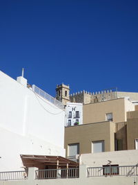 Low angle view of buildings against clear blue sky