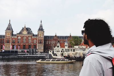 Boat in river with buildings in background