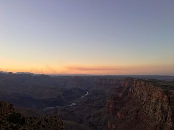 Scenic view of dramatic landscape against sky during sunset